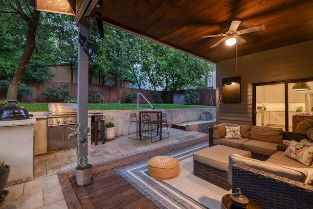 1303 Deloney St, Austin, TX 78721 - deck featuring a fenced backyard, exterior kitchen, a patio, an outdoor living space, and a ceiling fan