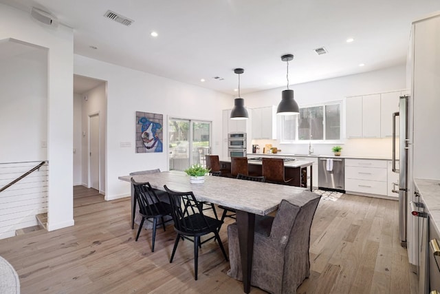 1303 Deloney St, Austin, TX 78721 - dining space with light wood-style flooring and recessed lighting