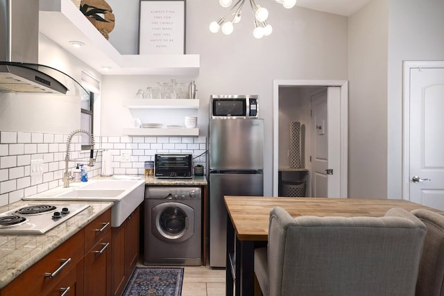 1305 Deloney St, Austin, TX 78721 - kitchen featuring washer / clothes dryer, stainless steel appliances, extractor fan, tasteful backsplash, and a chandelier