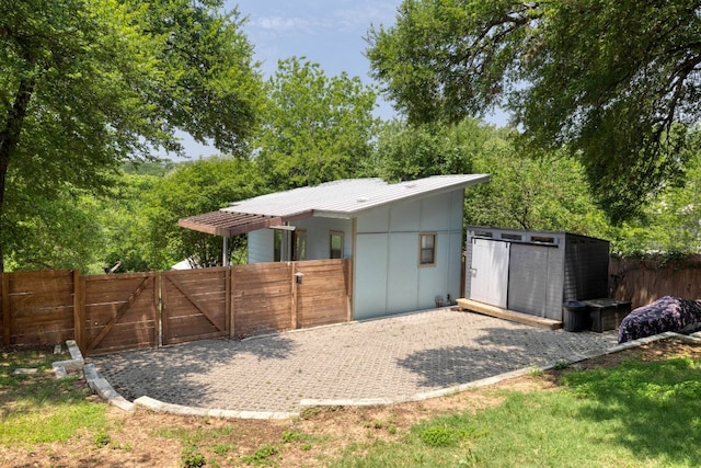 1305 Deloney St, Austin, TX 78721 - rear view of house with a gate and a metal roof