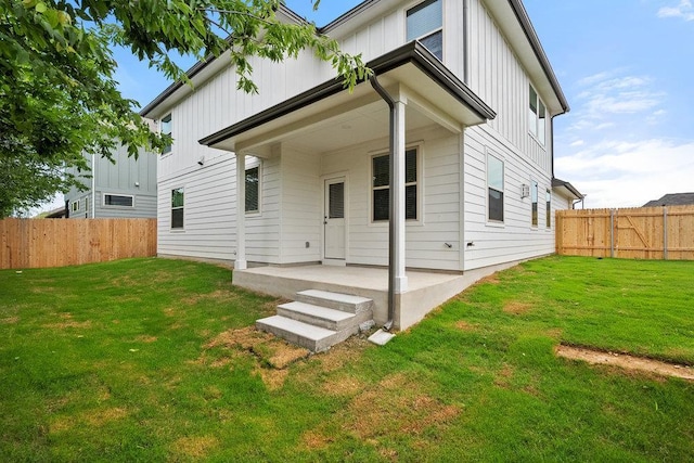 13228 Ditka Dr, Austin, TX 78652 - back of house with board and batten siding, a patio area, and a fenced backyard