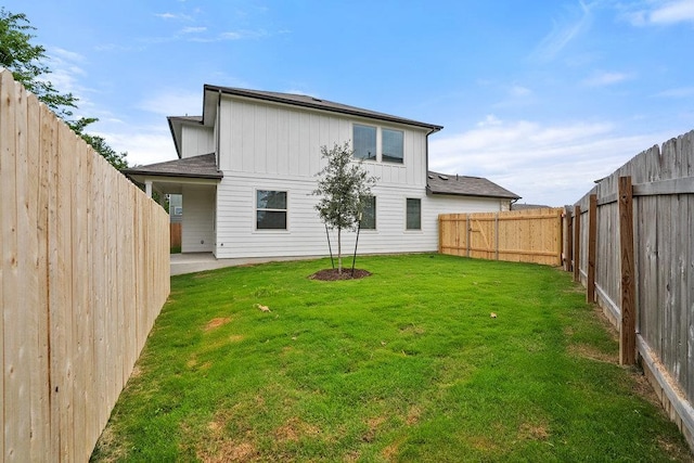 13228 Ditka Dr, Austin, TX 78652 - rear view of house featuring board and batten siding, a fenced backyard, and a patio area