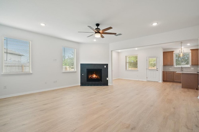 13228 Ditka Dr, Austin, TX 78652 - unfurnished living room with a ceiling fan, recessed lighting, light wood-type flooring, and a fireplace