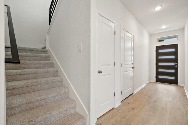 13228 Ditka Dr, Austin, TX 78652 - entryway featuring stairway, light wood finished floors, and recessed lighting