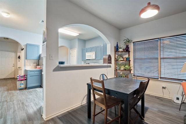 9206 Brents Elm Dr, Austin, TX 78744 - dining space featuring wood finished floors and arched walkways