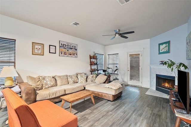 9206 Brents Elm Dr, Austin, TX 78744 - living room featuring wood finished floors, ceiling fan, and a premium fireplace