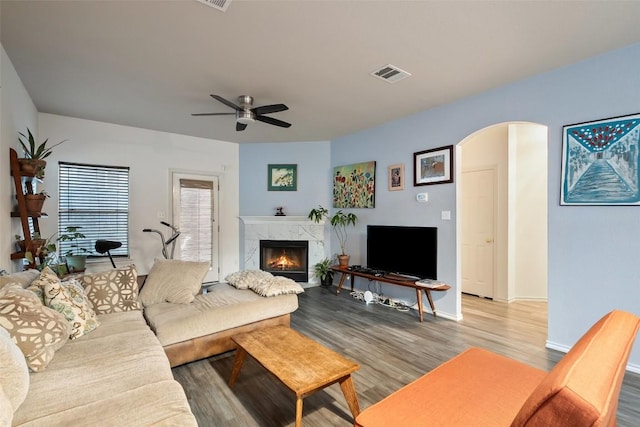 9206 Brents Elm Dr, Austin, TX 78744 - living area with a high end fireplace, wood finished floors, ceiling fan, and arched walkways