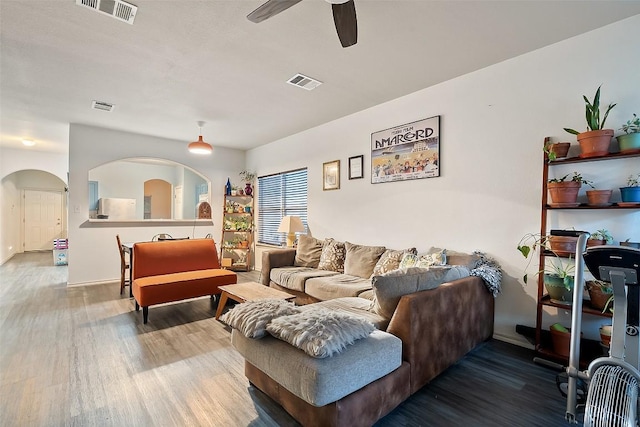 9206 Brents Elm Dr, Austin, TX 78744 - living area with wood finished floors, ceiling fan, and arched walkways
