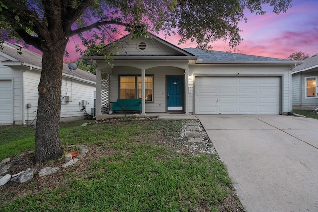 9206 Brents Elm Dr, Austin, TX 78744 - view of front of home featuring covered porch, a garage, and driveway