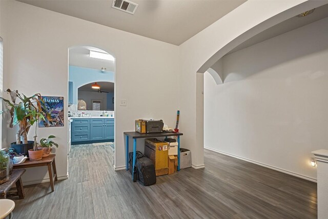 9206 Brents Elm Dr, Austin, TX 78744 - hallway with wood finished floors and arched walkways