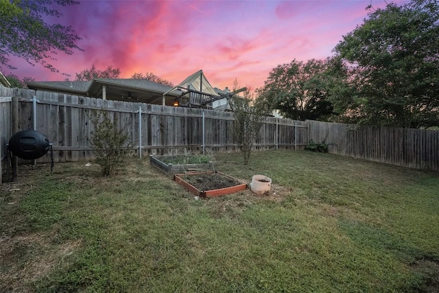 9206 Brents Elm Dr, Austin, TX 78744 - yard at dusk featuring a garden and a fenced backyard