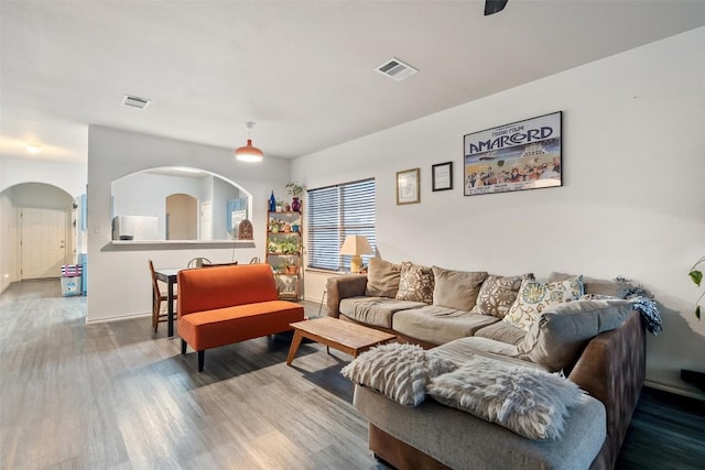 9206 Brents Elm Dr, Austin, TX 78744 - living room with wood finished floors and arched walkways