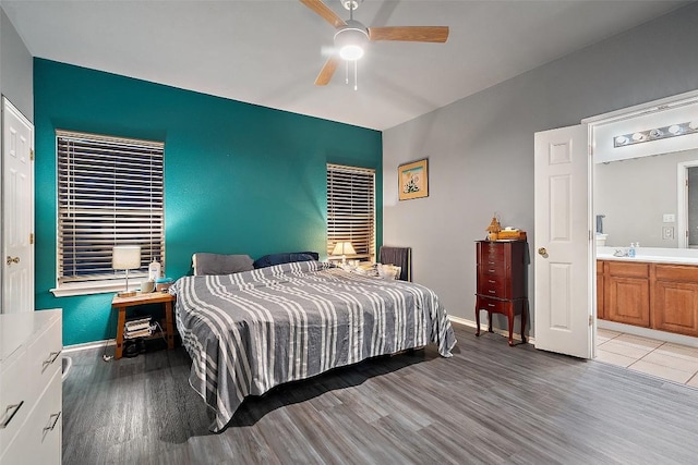 9206 Brents Elm Dr, Austin, TX 78744 - bedroom featuring light wood-style flooring, ensuite bathroom, and ceiling fan