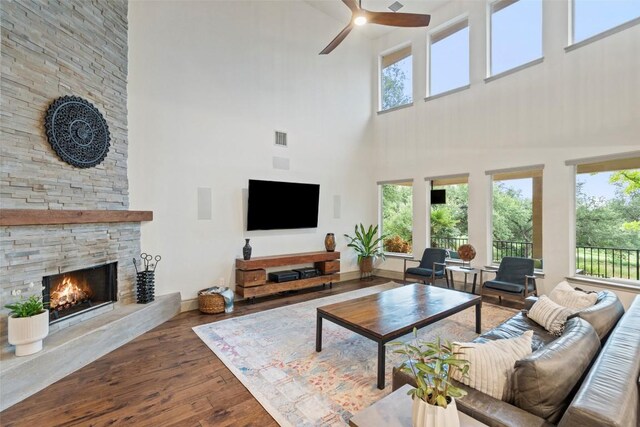 15908 Spillman Ranch Loop, Austin, TX 78738 - living room with a towering ceiling, a fireplace, a ceiling fan, wood-type flooring, and healthy amount of natural light