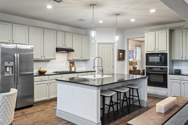 15908 Spillman Ranch Loop, Austin, TX 78738 - kitchen featuring black appliances, dark countertops, tasteful backsplash, a breakfast bar area, and recessed lighting