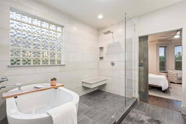 15908 Spillman Ranch Loop, Austin, TX 78738 - bathroom with walk in shower, a freestanding bath, tile walls, wood finished floors, and ceiling fan