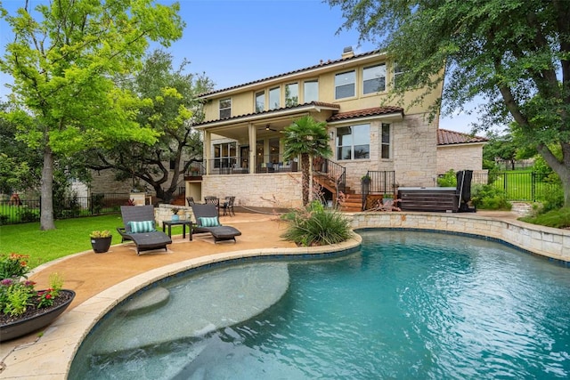 15908 Spillman Ranch Loop, Austin, TX 78738 - rear view of house featuring stone siding, a ceiling fan, stairway, a patio, and a tile roof