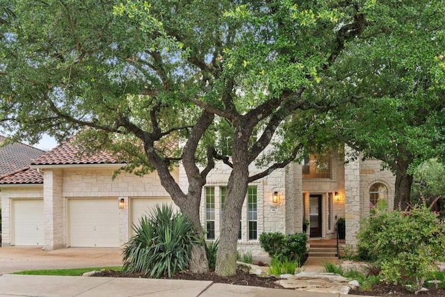 15908 Spillman Ranch Loop, Austin, TX 78738 - view of front of property with stone siding, concrete driveway, and an attached garage