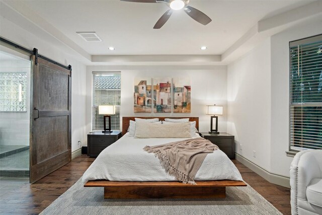 15908 Spillman Ranch Loop, Austin, TX 78738 - bedroom featuring a barn door, dark wood-style flooring, ceiling fan, and recessed lighting