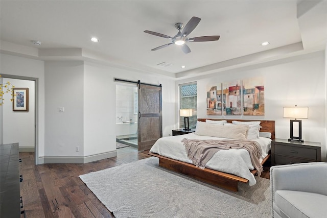 15908 Spillman Ranch Loop, Austin, TX 78738 - bedroom with a barn door, wood finished floors, a tray ceiling, recessed lighting, and ceiling fan