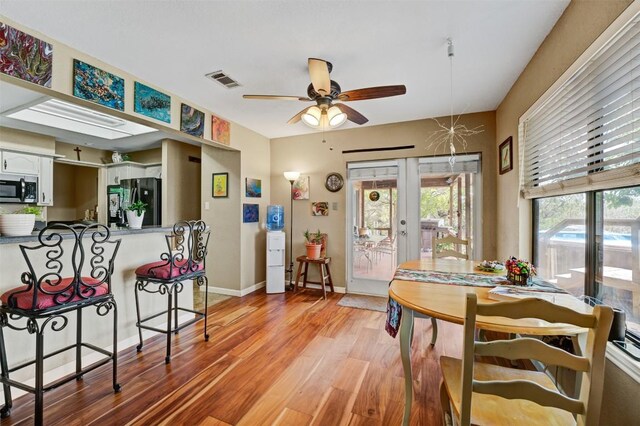 21013 Ridgeview Loop, Lago Vista, TX 78645 - dining room featuring a ceiling fan, light wood-style floors, and french doors