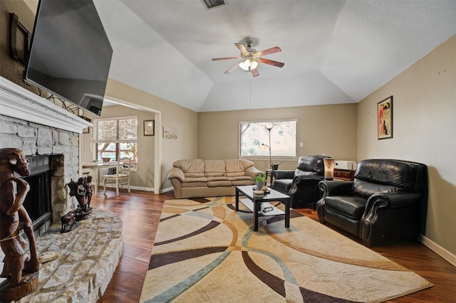 21013 Ridgeview Loop, Lago Vista, TX 78645 - living area with wood finished floors, a ceiling fan, a stone fireplace, and vaulted ceiling