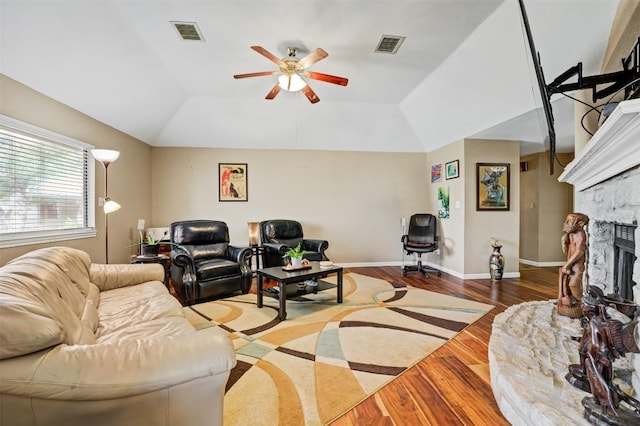 21013 Ridgeview Loop, Lago Vista, TX 78645 - living area with wood finished floors, ceiling fan, vaulted ceiling, and a stone fireplace