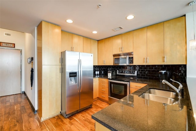 360 Nueces St Unit 3807, Austin, TX 78701 - kitchen featuring appliances with stainless steel finishes, light brown cabinetry, light wood-style flooring, and recessed lighting