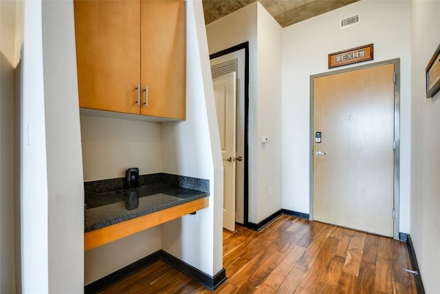 360 Nueces St Unit 3807, Austin, TX 78701 - kitchen with dark wood-type flooring and dark stone counters
