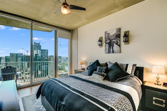 360 Nueces St Unit 3807, Austin, TX 78701 - bedroom featuring floor to ceiling windows, a skyline view, wood finished floors, access to outside, and ceiling fan