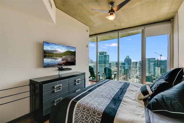 360 Nueces St Unit 3807, Austin, TX 78701 - bedroom with a wall of windows, access to exterior, and wood finished floors