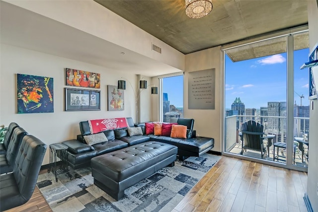 360 Nueces St Unit 3807, Austin, TX 78701 - living room with healthy amount of natural light, wood finished floors, a city view, and expansive windows