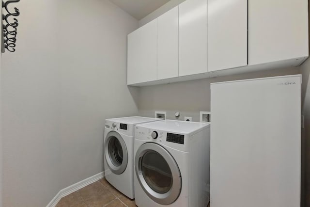 7617 Roaring Springs Dr, Austin, TX 78736 - laundry room featuring cabinet space, washer and clothes dryer, and light tile patterned flooring