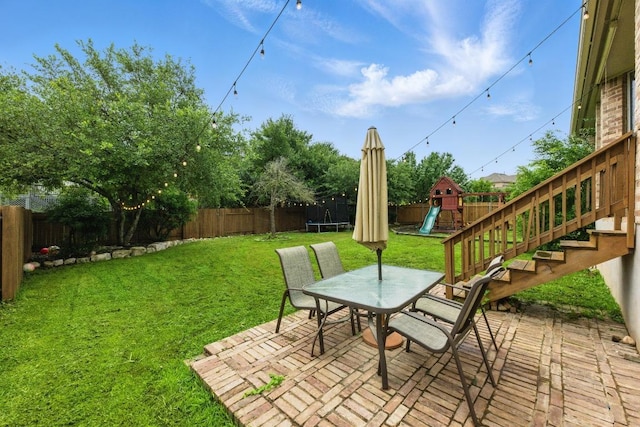7617 Roaring Springs Dr, Austin, TX 78736 - fenced backyard featuring a trampoline, a playground, a patio, and outdoor dining area