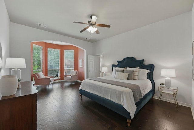 7617 Roaring Springs Dr, Austin, TX 78736 - bedroom with arched walkways, dark wood-style flooring, and ceiling fan