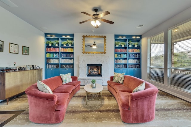 7617 Roaring Springs Dr, Austin, TX 78736 - living area with built in shelves, concrete flooring, a ceiling fan, and a premium fireplace