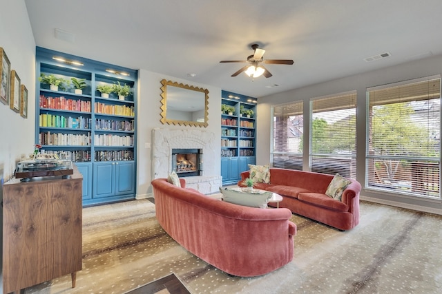 7617 Roaring Springs Dr, Austin, TX 78736 - living room featuring ceiling fan, a stone fireplace, and built in features