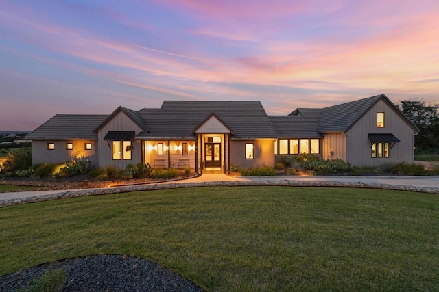 111 Rock N Robyn Trl, Horseshoe Bay, TX 78657 - modern inspired farmhouse with board and batten siding, a front lawn, a tile roof, and curved driveway