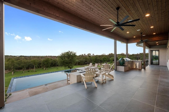 111 Rock N Robyn Trl, Horseshoe Bay, TX 78657 - view of patio with an outdoor kitchen, a ceiling fan, and an outdoor pool