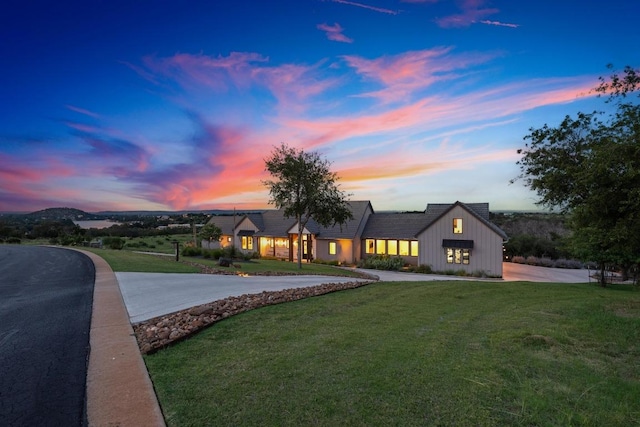 111 Rock N Robyn Trl, Horseshoe Bay, TX 78657 - view of front facade with curved driveway, board and batten siding, and a front yard
