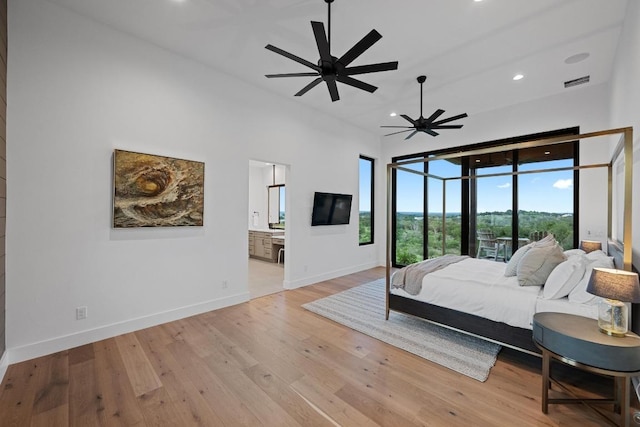 111 Rock N Robyn Trl, Horseshoe Bay, TX 78657 - bedroom with light wood-type flooring, recessed lighting, connected bathroom, and ceiling fan