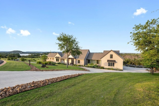 111 Rock N Robyn Trl, Horseshoe Bay, TX 78657 - view of front facade featuring board and batten siding, a front yard, and curved driveway