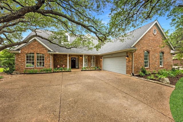 509 Explorer Dr, Lakeway, TX 78734 - traditional-style home featuring a shingled roof, a garage, brick siding, and concrete driveway