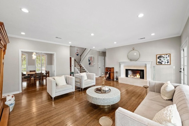 509 Explorer Dr, Lakeway, TX 78734 - living room featuring stairway, a fireplace, recessed lighting, wood finished floors, and ornamental molding
