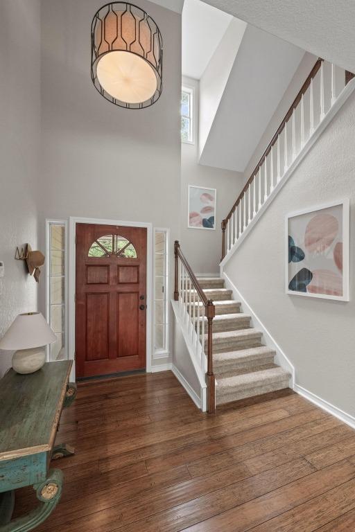 509 Explorer Dr, Lakeway, TX 78734 - foyer entrance featuring a high ceiling, hardwood / wood-style floors, and stairs