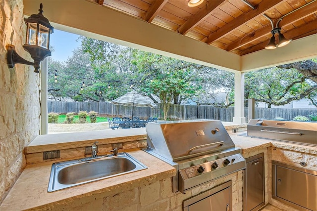 7503 Stonecliff Cir, Austin, TX 78731 - fenced backyard with a sink and exterior kitchen