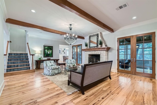 7503 Stonecliff Cir, Austin, TX 78731 - living area with french doors, beamed ceiling, wood finished floors, a large fireplace, and ornamental molding
