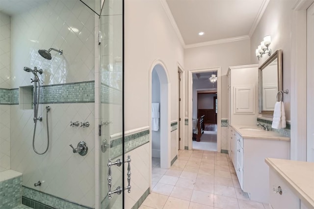 7503 Stonecliff Cir, Austin, TX 78731 - ensuite bathroom featuring ornamental molding, tile patterned flooring, tiled shower, vanity, and a ceiling fan