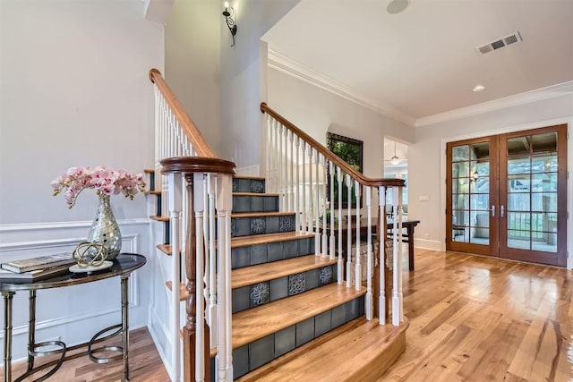 7503 Stonecliff Cir, Austin, TX 78731 - stairs featuring french doors, crown molding, and wood finished floors