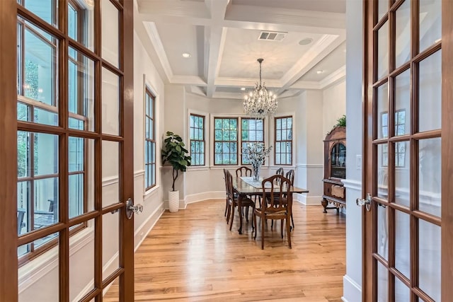 7503 Stonecliff Cir, Austin, TX 78731 - dining space featuring french doors, a chandelier, coffered ceiling, light wood-style floors, and beamed ceiling